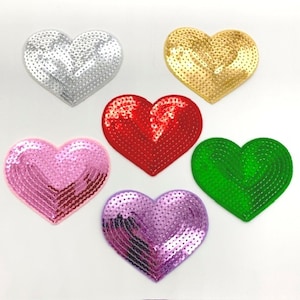 May include: Six heart-shaped sequin patches in different colors: silver, gold, red, pink, green, and purple.