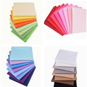 May include: A collection of four separate stacks of folded fabric squares. The stacks feature a wide variety of solid colours, including shades of beige, yellow, orange, green, red, pink, light blue, purple, white, grey, brown, and black.