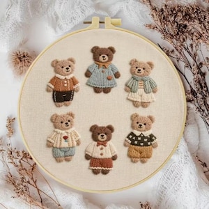 May include: Embroidered hoop art showing six teddy bears dressed in miniature outfits. The bears are in shades of brown and beige, with clothing in blue, orange, and green. The embroidery is on a cream-coloured fabric stretched within a wooden hoop.