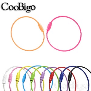 May include: Assortment of colorful metal key rings with a twisted cable design. The key rings are available in orange, pink, white, yellow, green, purple, light blue, dark blue, red, and black.