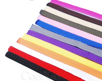 May include: A variety of colors of woven ribbon, including pink, brown, beige, green, blue, gray, purple, yellow, orange, white, red, and black.
