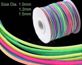 May include: A spool of colourful elastic cord in various neon colours, including green, yellow, pink, blue, and orange. The cord is wound around a white cardboard spool. The text "Size Dia. 1.0mm 1.2mm 1.5mm" is printed on the image.