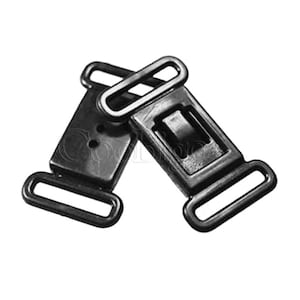 May include: Two black plastic clasps with a sliding buckle and a loop on each end. The clasps are designed for attaching straps or fabric.