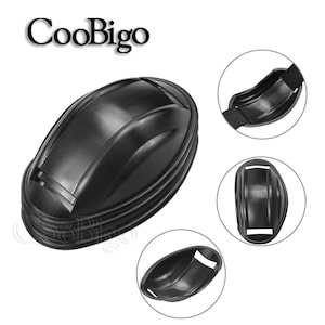 Può includere: Casco in plastica nera con una superficie liscia e arrotondata e un design testurizzato e nervato. Il casco è progettato per proteggere la testa e il collo.