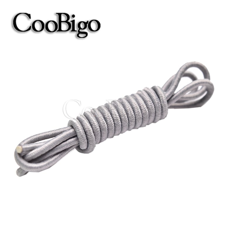May include: A coiled length of gray elastic shoelaces. The shoelaces are made of a woven material and are designed to be used in place of traditional shoelaces.
