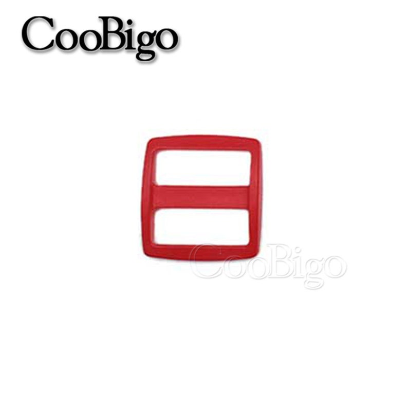 May include: Red plastic slider buckle for straps or belts. The buckle has two slots for the strap to pass through.