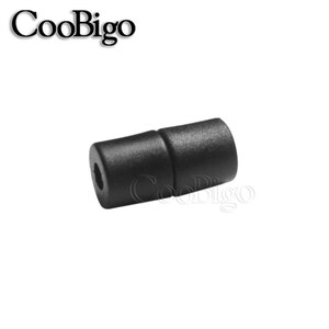 May include: Black plastic cord end cap. The cap has a smooth, rounded surface and a small hole in the center.