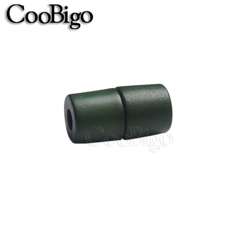 May include: A dark green plastic toggle clasp for jewellery making. The clasp is made of two pieces that snap together.