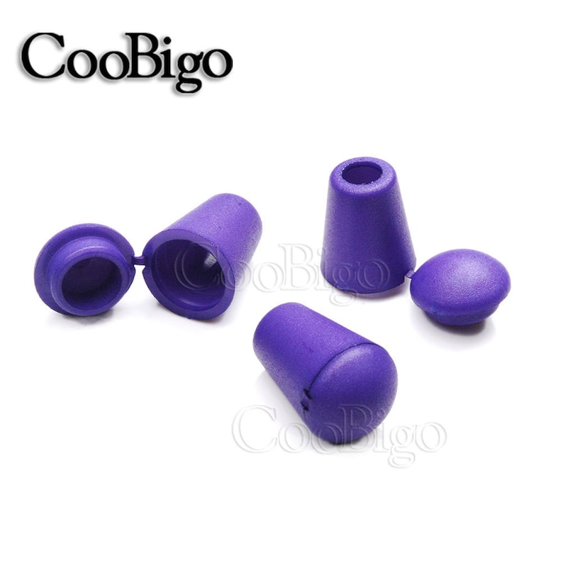 May include: Four purple plastic cord ends with a cap and a separate piece that snaps on. The cord ends are designed to be used on shoelaces, drawstrings, or other cords.