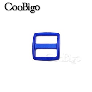 May include: A blue plastic buckle with a square shape and two horizontal bars. The buckle is used for securing straps or belts.