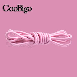 Peut inclure: Cordon &eacute;lastique rose, un type de ficelle utilis&eacute; pour l'artisanat et les projets de couture.