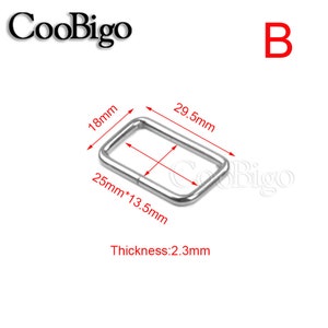 May include: A rectangular metal buckle with rounded corners. The buckle measures 29.5mm long, 25mm wide, 18mm high, and 13.5mm across the inside. The thickness is 2.3mm. The letter "B" is in red in the upper right corner.