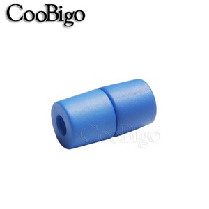 May include: A close-up of a blue plastic cord lock. The cord lock is made of two pieces that snap together.