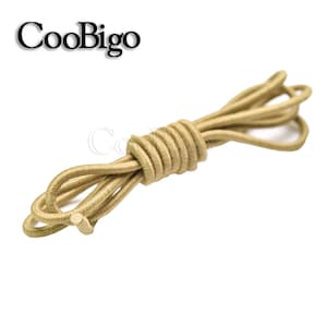 May include: A close-up of a beige elastic shoelace, coiled and ready to be used. The shoelace is made of a soft, flexible material and is perfect for replacing worn-out laces or adding a touch of style to your shoes.