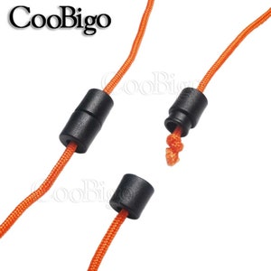 May include: Two black plastic cord ends with orange cord threaded through them. The cord ends are designed to secure the cord and prevent fraying.