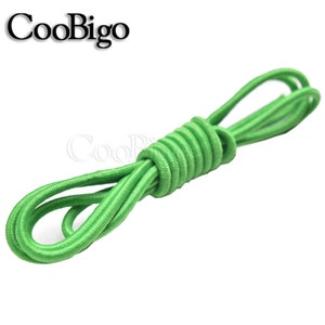 May include: A bright green elastic cord, coiled and ready for use. This versatile cord is perfect for a variety of crafting and DIY projects.