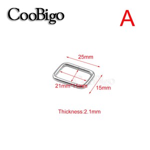May include: A silver-colored rectangular metal ring with dimensions of 25mm x 21mm. The thickness is 2.1mm. The image also includes the text "CooBigo" and the letter "A" in red.