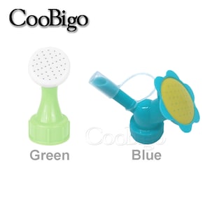 May include: Two plastic watering can attachments, one green and one blue. The green attachment has a round sprinkler head, while the blue attachment has a flower-shaped sprinkler head.