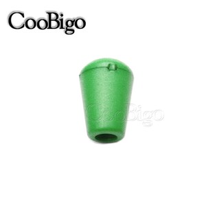 May include: A green plastic cord end stop with a small hole in the top. The cord end stop is designed to prevent fraying and keep cords secure.