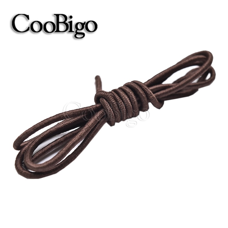 May include: Brown elastic shoelaces, a type of no-tie shoelace, are coiled together on a white background.