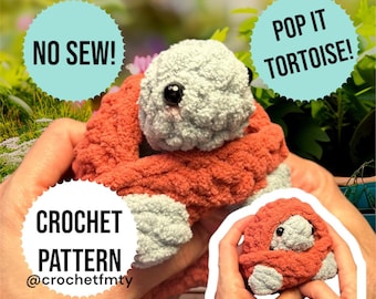 May include: A handmade crochet turtle in shades of gray and orange. The turtle has large black eyes and is held in a person's hands. Text on the image reads "NO SEW!", "POP IT TORTOISE!", and "CROCHET PATTERN @crochetfmty".