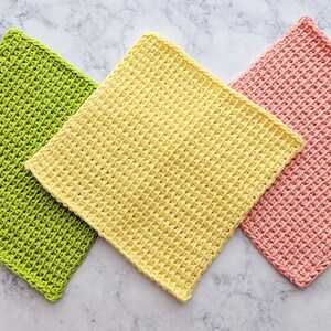 May include: Three crocheted dishcloths in different colors: green, yellow, and pink. The dishcloths are made with a textured stitch.