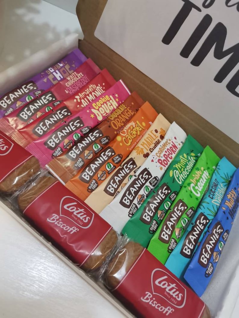 May include: A gift box filled with a variety of individually wrapped sugar-free beanies in flavors like cookie dough, creamy orange, and maple fudge. The box also includes two Lotus Biscoff cookies.