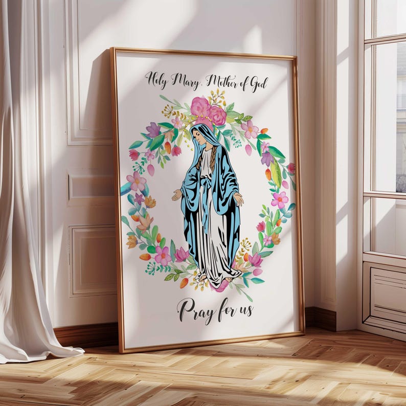 May include: A white background with a watercolor floral wreath surrounding a depiction of the Virgin Mary. The text "Holy Mary, Mother of God" is at the top and "Pray for us" is at the bottom.