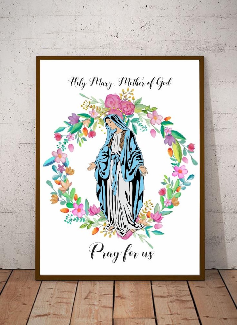 May include: A white background with a watercolor illustration of the Virgin Mary in a blue robe standing in a wreath of colorful flowers. The text "Holy Mary, Mother of God" is above the image and "Pray for us" is below the image.