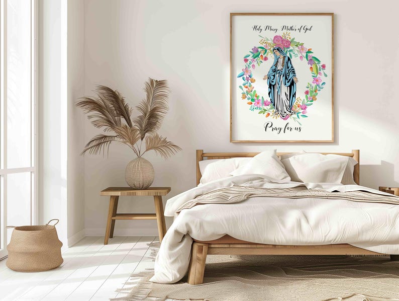 May include: A white framed print with a watercolor illustration of the Virgin Mary in a blue robe surrounded by a wreath of flowers. The text "Holy Mary Mother of God" and "Pray for us" is printed below the image.