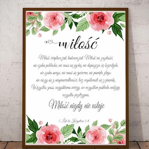 May include: A white framed print with a floral border and a quote about love in Polish. The quote reads "Miłość cierpliwa jest, łaskawa jest. Miłość nie zazdrości, nie szuka poklasku, nie unosi się pychą, nie dopuszcza się bozustydu, nie szuka swego, nie unosi się gniewem, nie pamięta złego: nie cieszy się z niesprawiedliwości, lecz współweseli się z prawdą. Wszystko znosi, wszystkiemu wierzy, we wszystkim pokłada nadzieję, wszystko przetrzyma. Miłość nigdy nie ustaje 1. List do Koryntian 4-8"