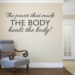 May include: A motivational quote on a wall in a room with a chair. The quote reads "The power that made THE BODY heals the body!"