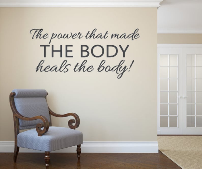 May include: A motivational quote on a wall in a room with a chair. The quote reads "The power that made THE BODY heals the body!"