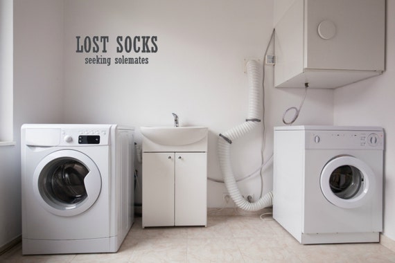 Lost socks seeking solemates vinyl wall decal. Perfect addition to a laundryroom. Add this to any display of missing socks.