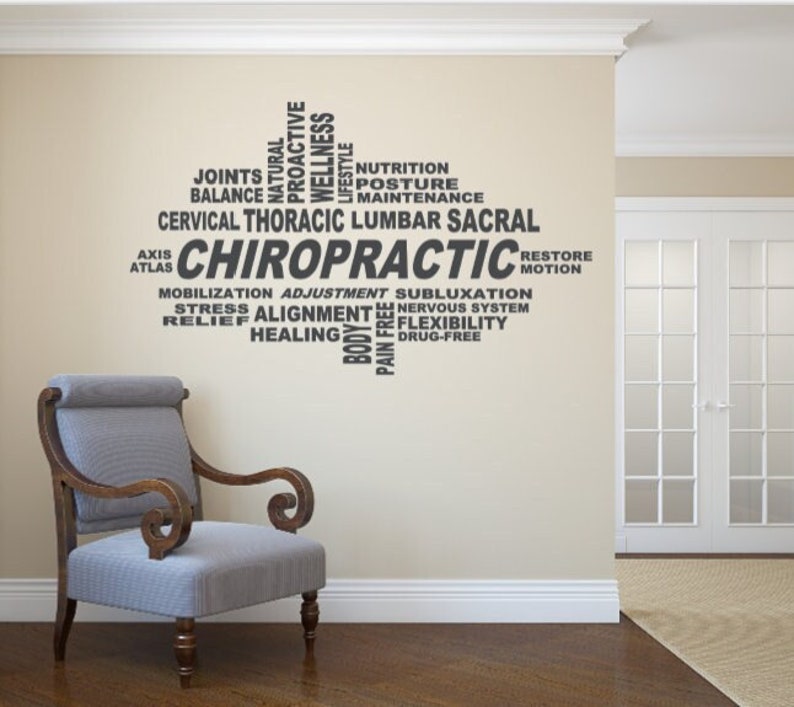 May include: A gray wall decal with the word "CHIROPRACTIC" in large letters surrounded by smaller words related to chiropractic care, such as "adjustment", "mobilization", "pain free", and "flexibility".