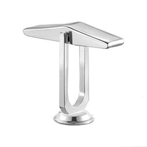 May include: A silver metal decorative stand with a unique design. The stand has a flat top and a U-shaped base.