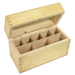 以下が含まれることがあります： 蓋付きの仕切り付き木製ボックス。ボックスは明るい色の木でできており、自然な仕上げになっています。ボックスは開いており、内部が見えます。内部は8つの区画に分けられています。