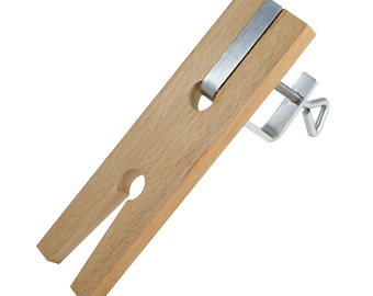 May include: A wooden clamp with a metal screw and a metal bar. The clamp is used to hold objects in place while working on them.