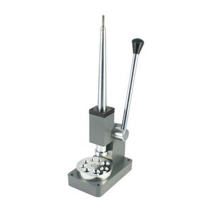 May include: A silver ring sizing tool with a black handle. The tool has a round base with multiple sizing rings and a vertical rod with a pointed tip.