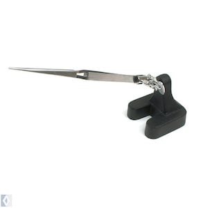 May include: A black and silver soldering station with a long, thin, pointed tweezer arm.