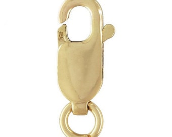 May include: A gold-colored lobster clasp with a spring-loaded gate and a small ring at the base. The clasp is made of a shiny, smooth metal and is designed for securing jewelry or other items. The clasp is shown against a white background.
