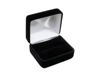 May include: A black velvet ring box with a white satin interior. The box is open and the lid is propped up.