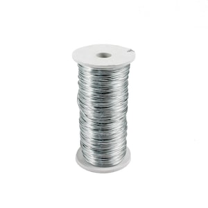 May include: A spool of silver-colored wire wrapped around a white cardboard cylinder.