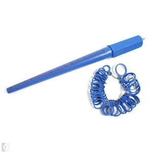 May include: A blue plastic ring sizer with a set of numbered rings and a ruler. The ruler is marked in inches.