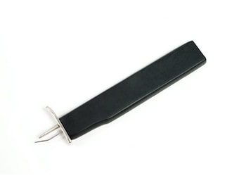 May include: A black plastic tool with a metal hook on one end and a metal loop on the other end. The tool is used for pulling thread through a needle.