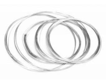 May include: A set of seven silver-colored wire rings, each with a different diameter, for jewelry making.