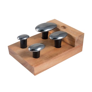 May include: Set of four oval-shaped metal tools with black handles, mounted on a wooden base. The tools are different sizes and are used for shaping metal.