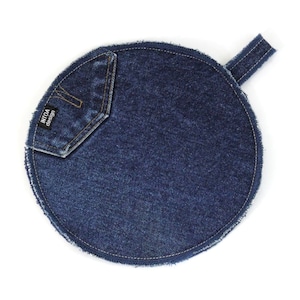 May include: A round blue denim pot holder with a small pocket and a loop handle. The pocket has the text "INTOA design" printed on it.