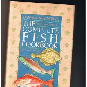 May include: The Complete Fish Cookbook by Dan and Inez Morris, a cookbook with a blue background and illustrations of fish, including a flounder, a trout, and a red snapper.