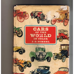 May include: A vintage book cover featuring a colorful illustration of various cars from around the world. The book title is "Cars of the World in Color" by J.D. Scheel.